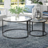 Set of Two 35" Black Glass And Steel Round Nested Coffee Tables